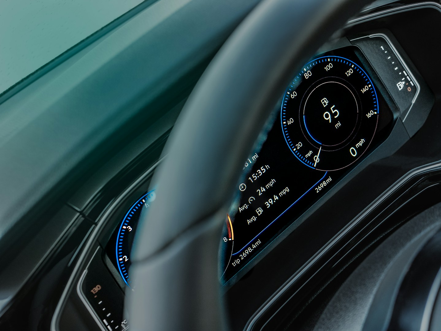gray car steering wheel and instrument panel cluster