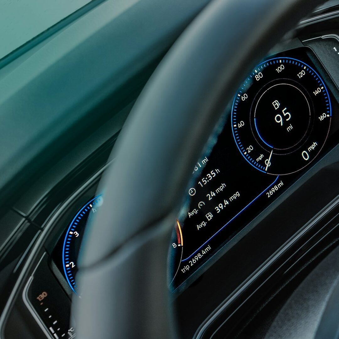 gray car steering wheel and instrument panel cluster